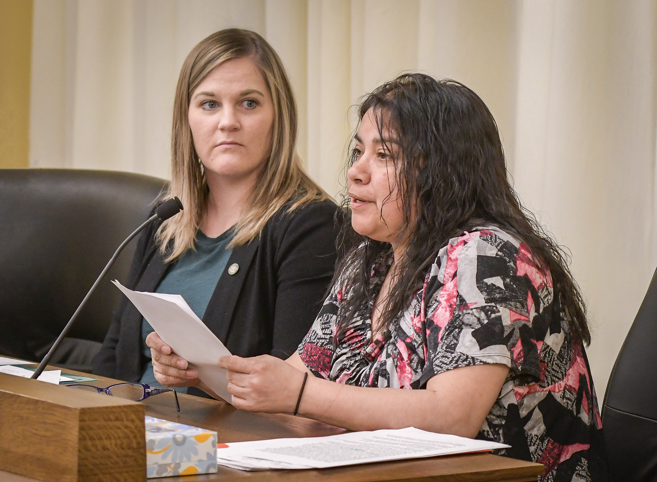 Jacqueline Arias of St. Paul testifies before the House Labor Committee Feb. 20 in support of a bill sponsored by Rep. Erin Koegel, left, that would fund a getting to work grant program. Photo by Andrew VonBank